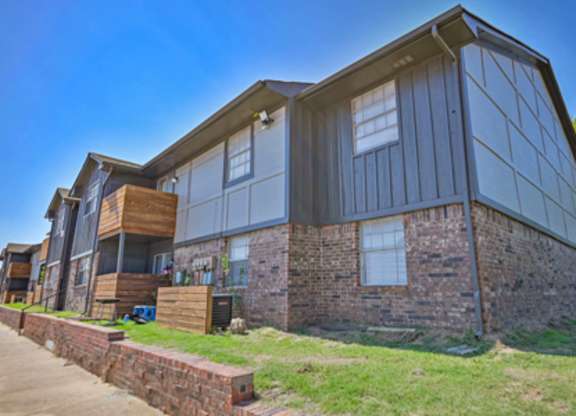 A modern house with a combination of brick and siding exterior.