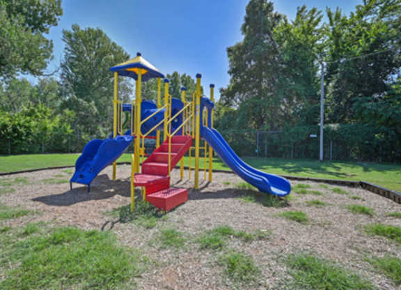 A playground with a blue slide and red steps.