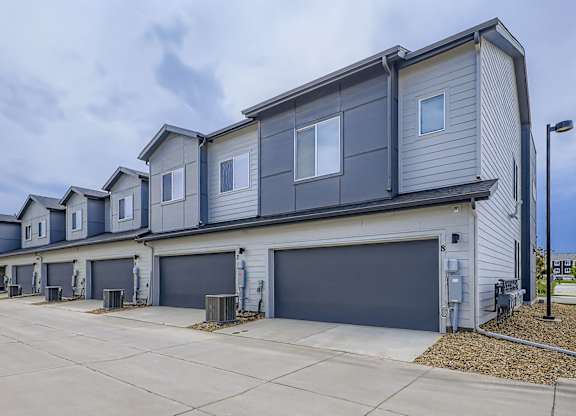 A row of houses with garages in front.