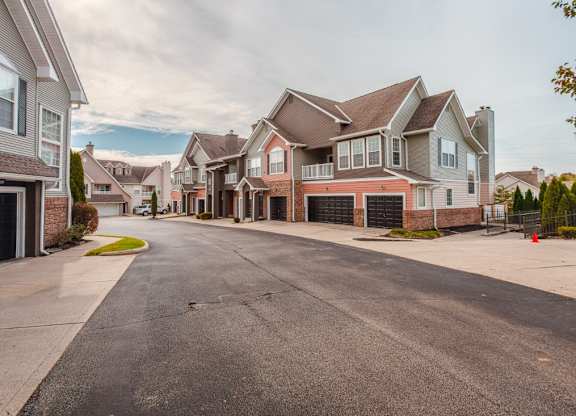 A street view of a residential area with houses on both sides.