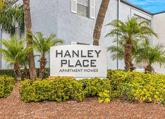 a sign for hanley place apartments in front of palm trees