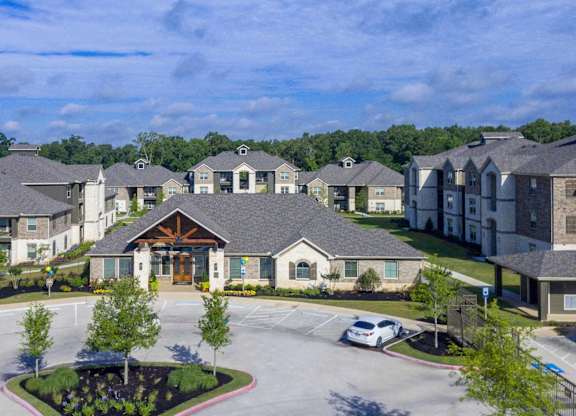 A large building with a parking lot in front of it.