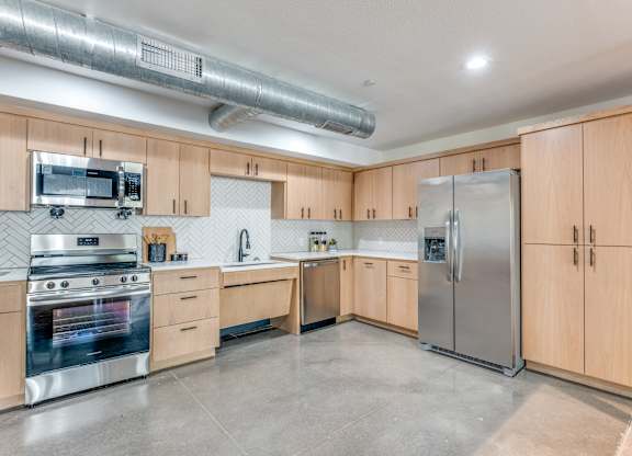 A kitchen with wooden cabinets and stainless steel appliances.