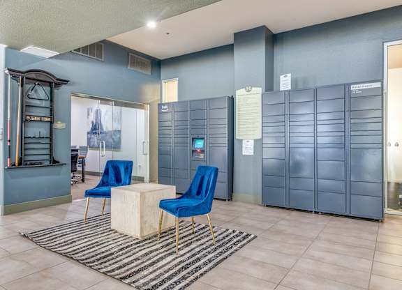 A room with blue chairs and a white table.