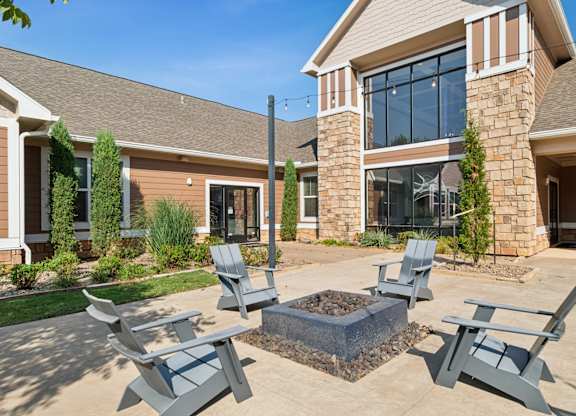 A house with a patio and four chairs.