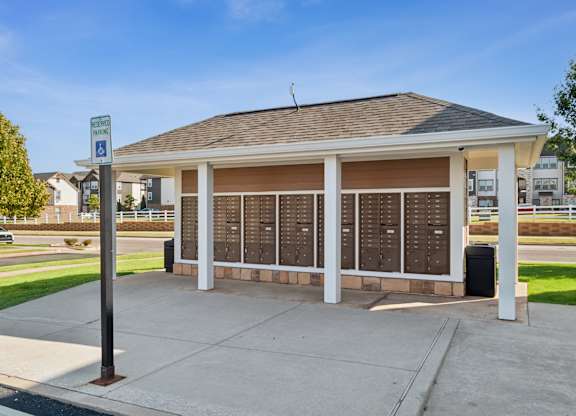 A covered waiting area with a sign for disabled parking.