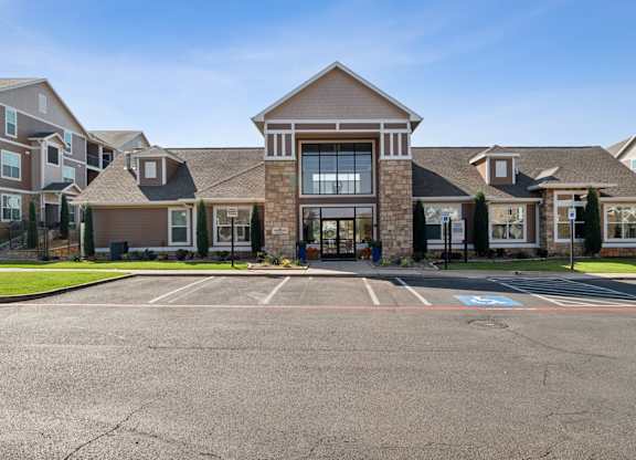 A large building with a parking lot in front of it.