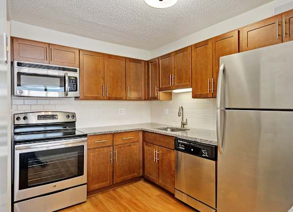 A kitchen with wooden cabinets and stainless steel appliances.