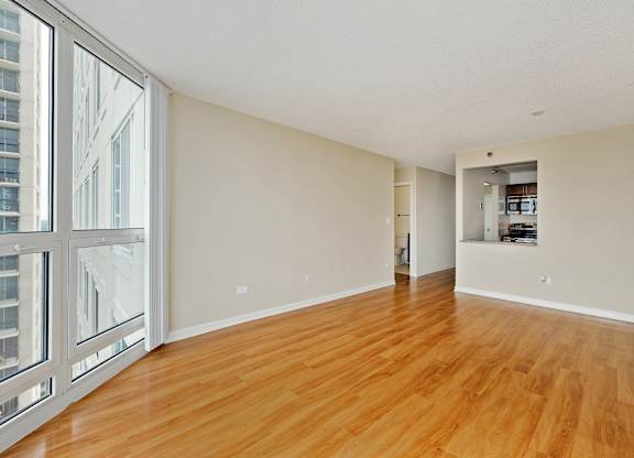 A room with wooden floors and white walls.