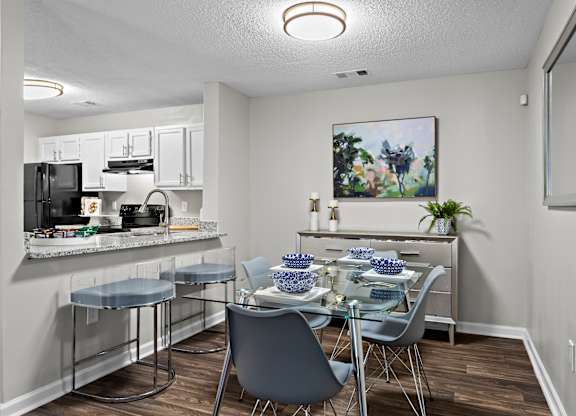 A kitchen with a dining table set for two.