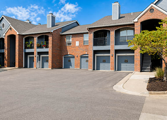 A large brick building with multiple garage doors.