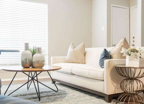 a living room with a couch and tables