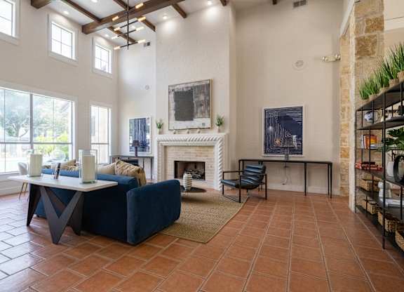 A living room with a fireplace and a painting on the wall.