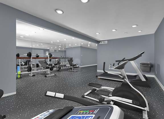 A gym with treadmills, weights, and exercise equipment.