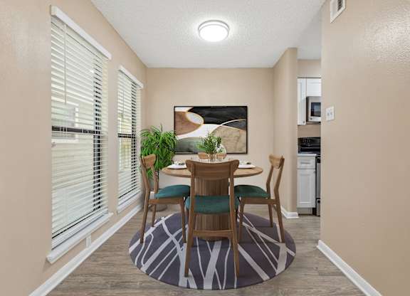 A dining room with a table set for two.