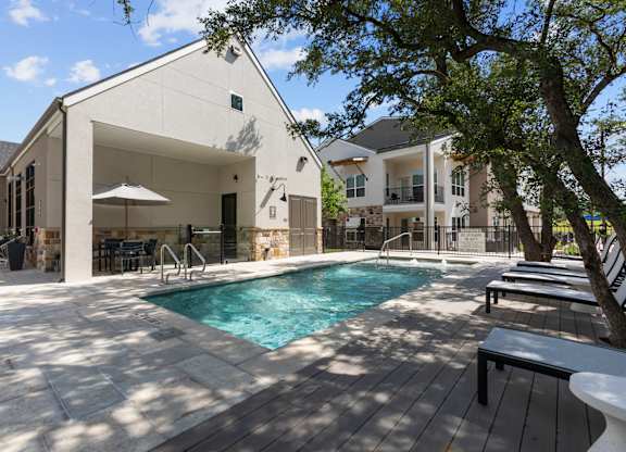 A modern house with a pool in the backyard.
