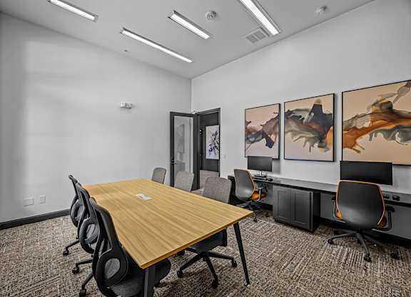 A conference room with a long table and chairs.