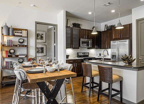 A modern kitchen with a dining table and chairs.