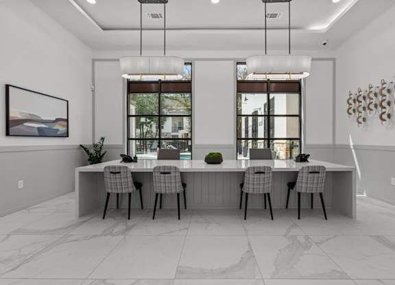 A modern dining room with a large table and chairs.