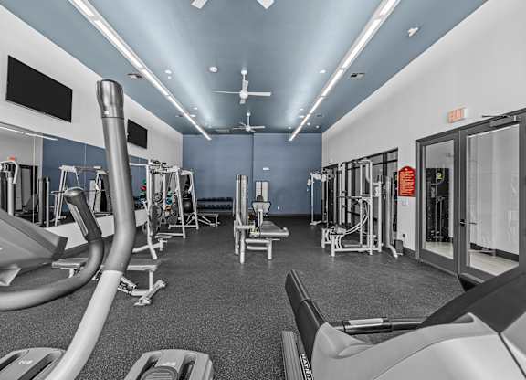 A gym with treadmills, elliptical machines, and other cardio equipment.