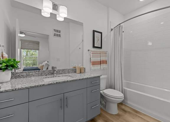 A bathroom with a toilet, sink, and bathtub.