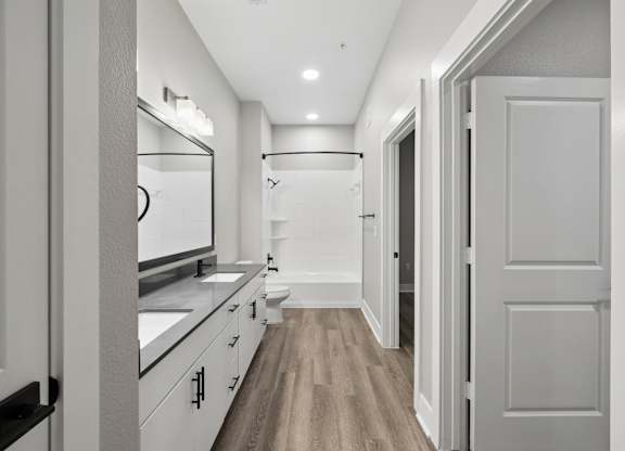 A long hallway with a white door on the right.