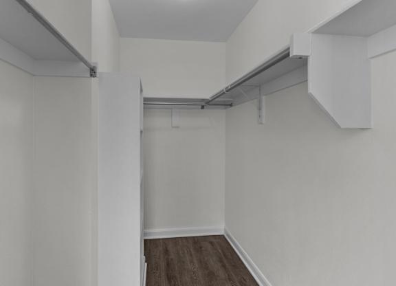 an empty room with white walls and a wood floor