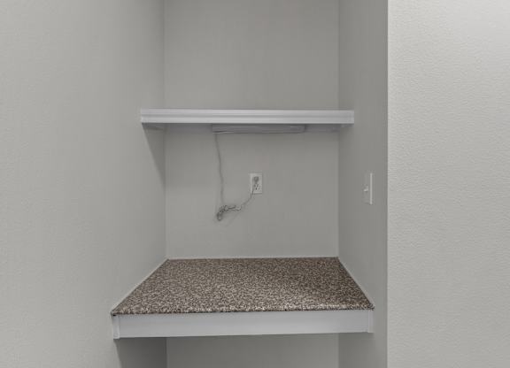 the closet in a bedroom of a house with an electrical outlet