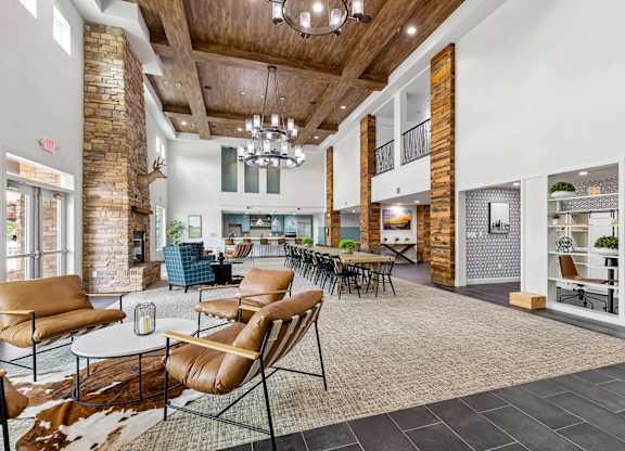 A large room with a stone pillar and a cowhide rug.