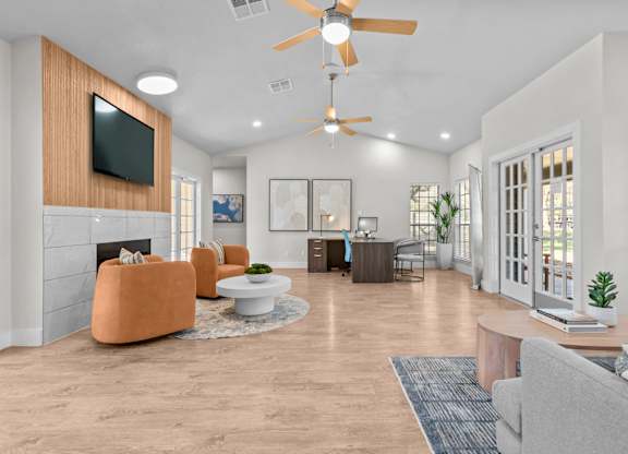 A living room with a television, a fireplace, and a ceiling fan.