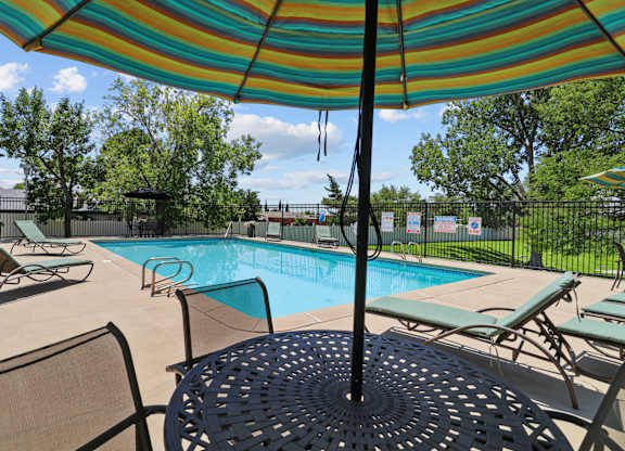 our apartments have a swimming pool with chairs and umbrellas