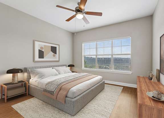 A bedroom with a bed, nightstand, and a ceiling fan.