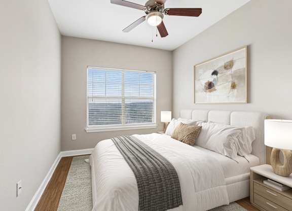 A bedroom with a bed, nightstand, and a ceiling fan.