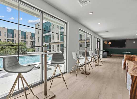 A modern dining room with a pool table and chairs.