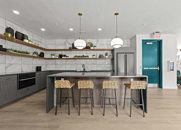 A kitchen with a bar area and stools.