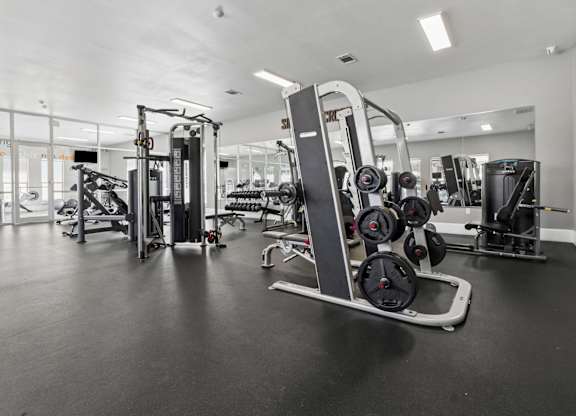 A gym with a variety of equipment including a leg press machine.