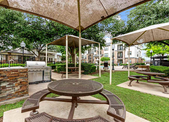 A patio with a table and chairs under a canopy.