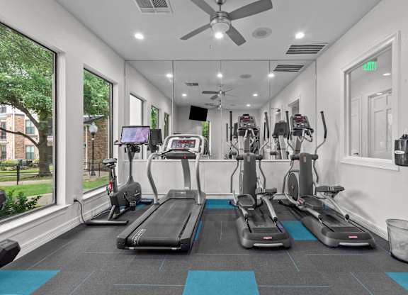 A gym with treadmills and exercise bikes.
