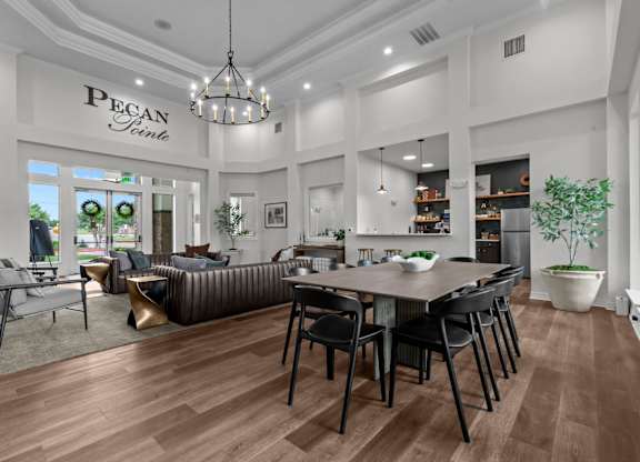 A modern living room with a dining area and a kitchen in the background.