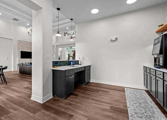A kitchen area with a counter and cabinets.