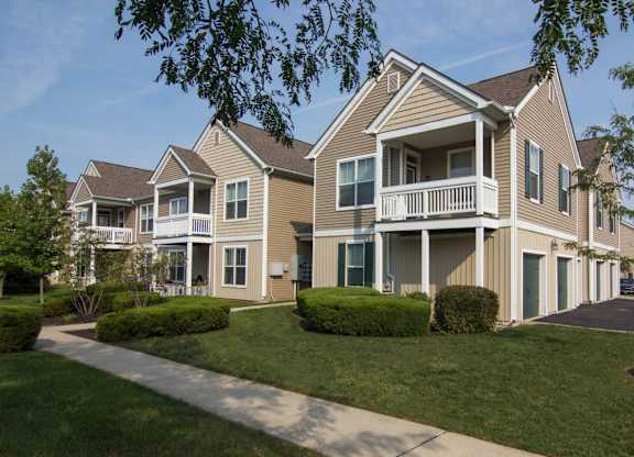A large, two-story house with a balcony on the second floor.