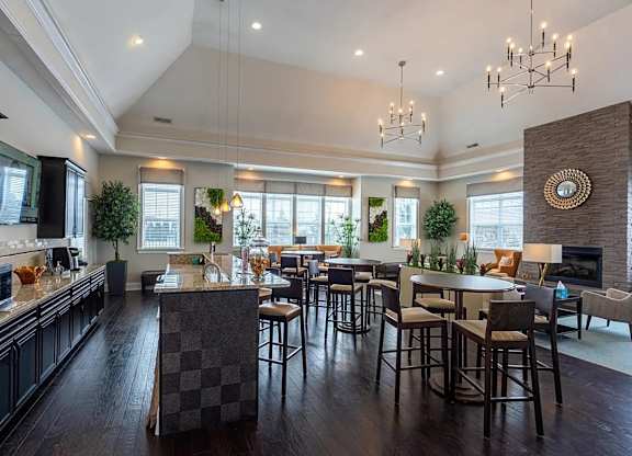 A large, well-lit kitchen with dark wood floors and a central island.