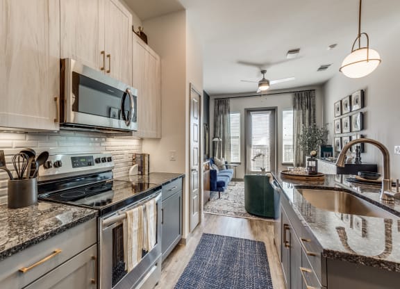 a kitchen with stainless steel appliances and granite counter tops