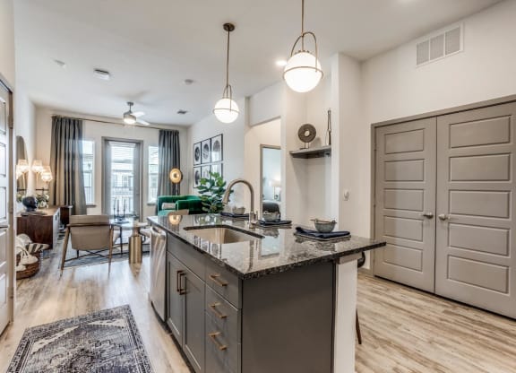 a kitchen with an island and a living room