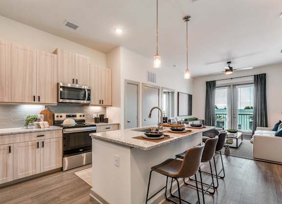 A modern kitchen with wooden cabinets and a large island.
