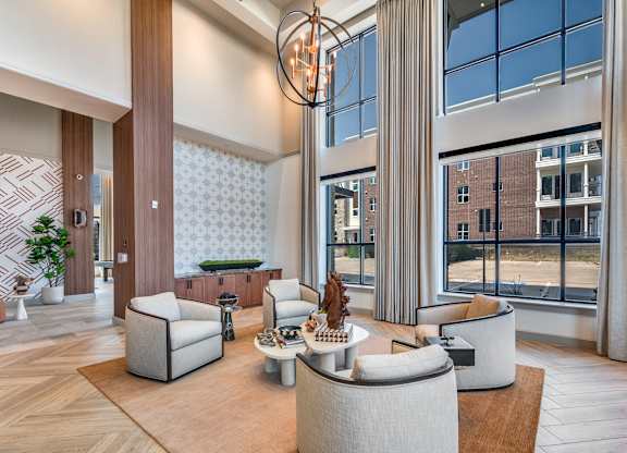 A modern living room with a large window and a view of a building outside.