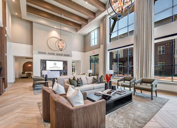 A modern living room with a large window and a fireplace.