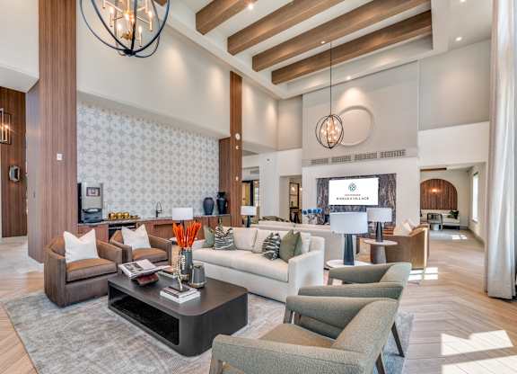 A modern living room with a dark wood floor and furniture.