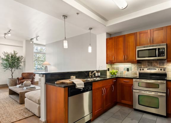 A modern kitchen with wooden cabinets and stainless steel appliances.