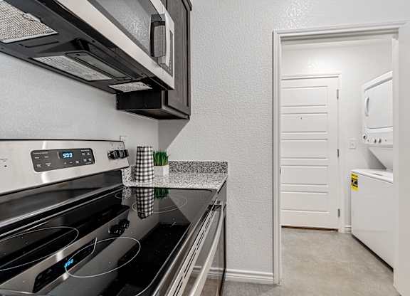 a kitchen with stainless steel appliances and a white door